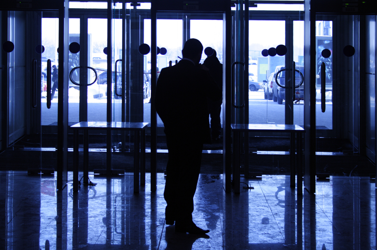 The security guard provides safety on an entrance in large business center